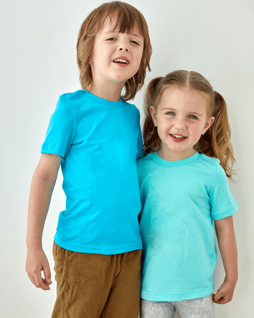 Two young siblings posing together
